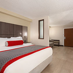 Ramada Orlando king executive suites have white bathtubs and showers