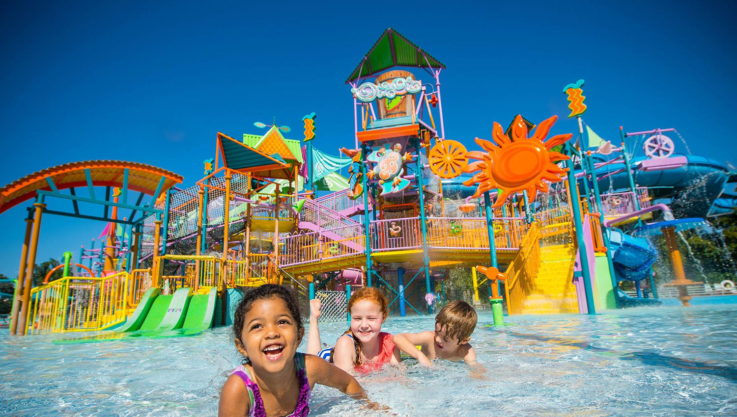 water theme park with kids swimming in the pool