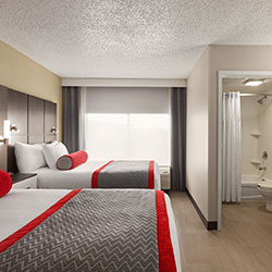 red twin beds while enjoying all comforts in a luxurious hotel suites
